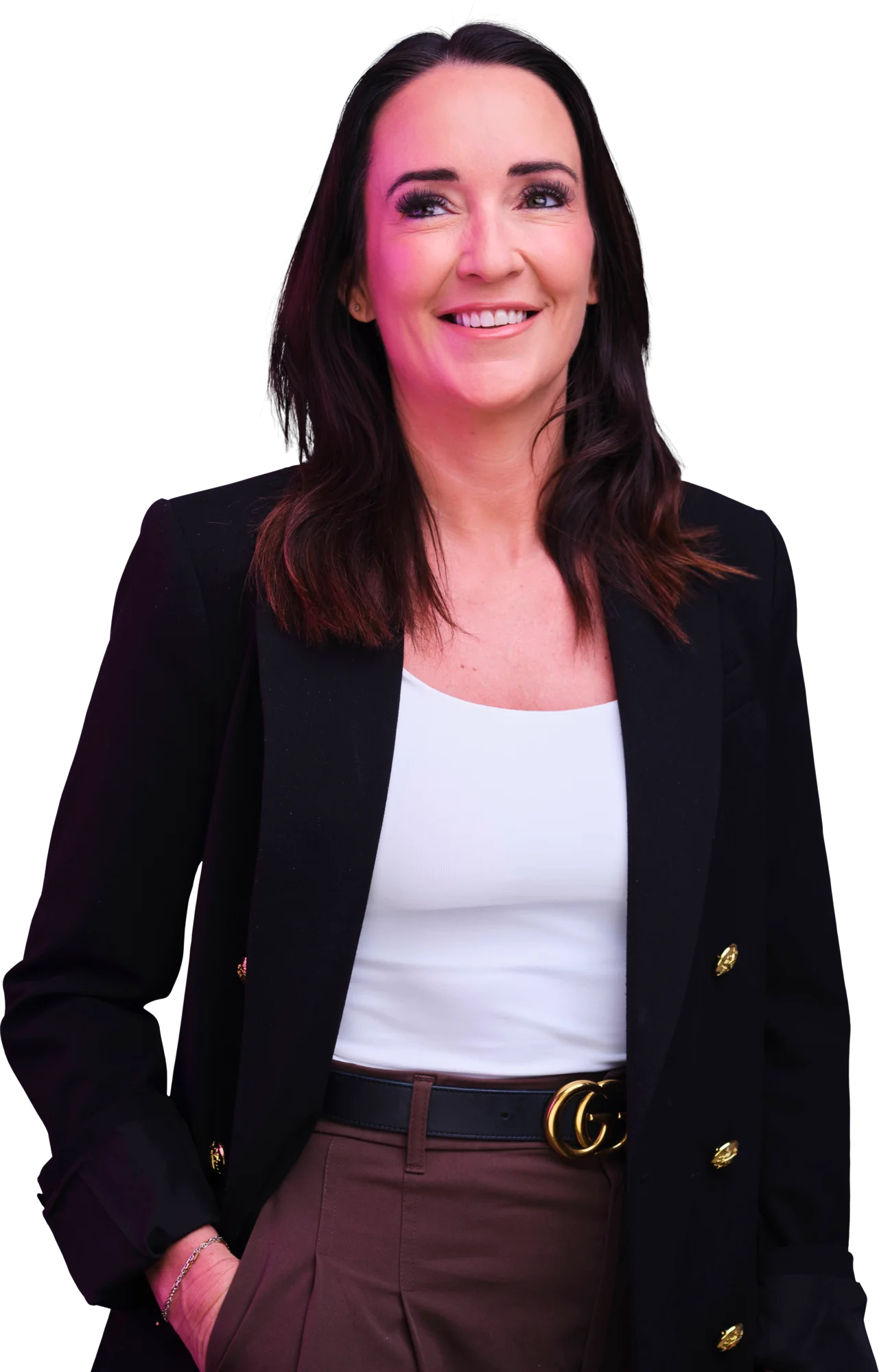Smiling woman with dark hair wearing a black blazer over a white top and brown pants.