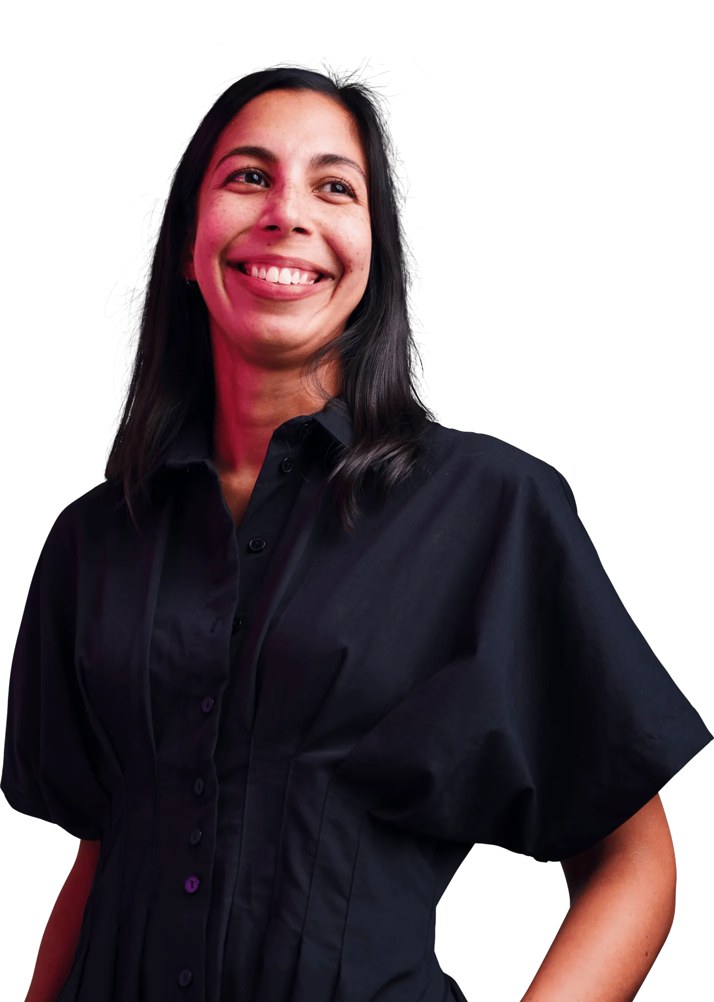 Smiling woman wearing a black blouse stands against a dark background.