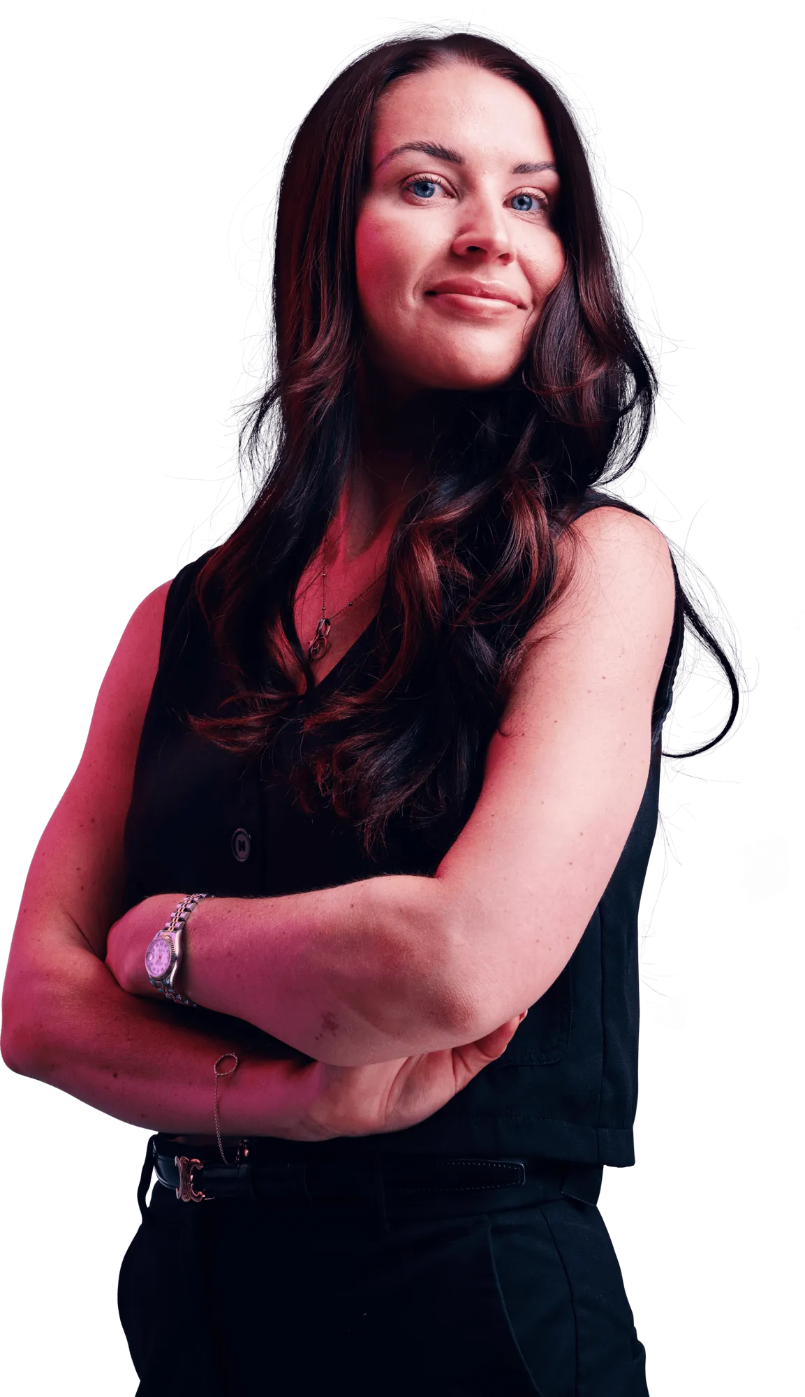 Portrait of a smiling woman with long dark hair, wearing a black sleeveless top, arms crossed.