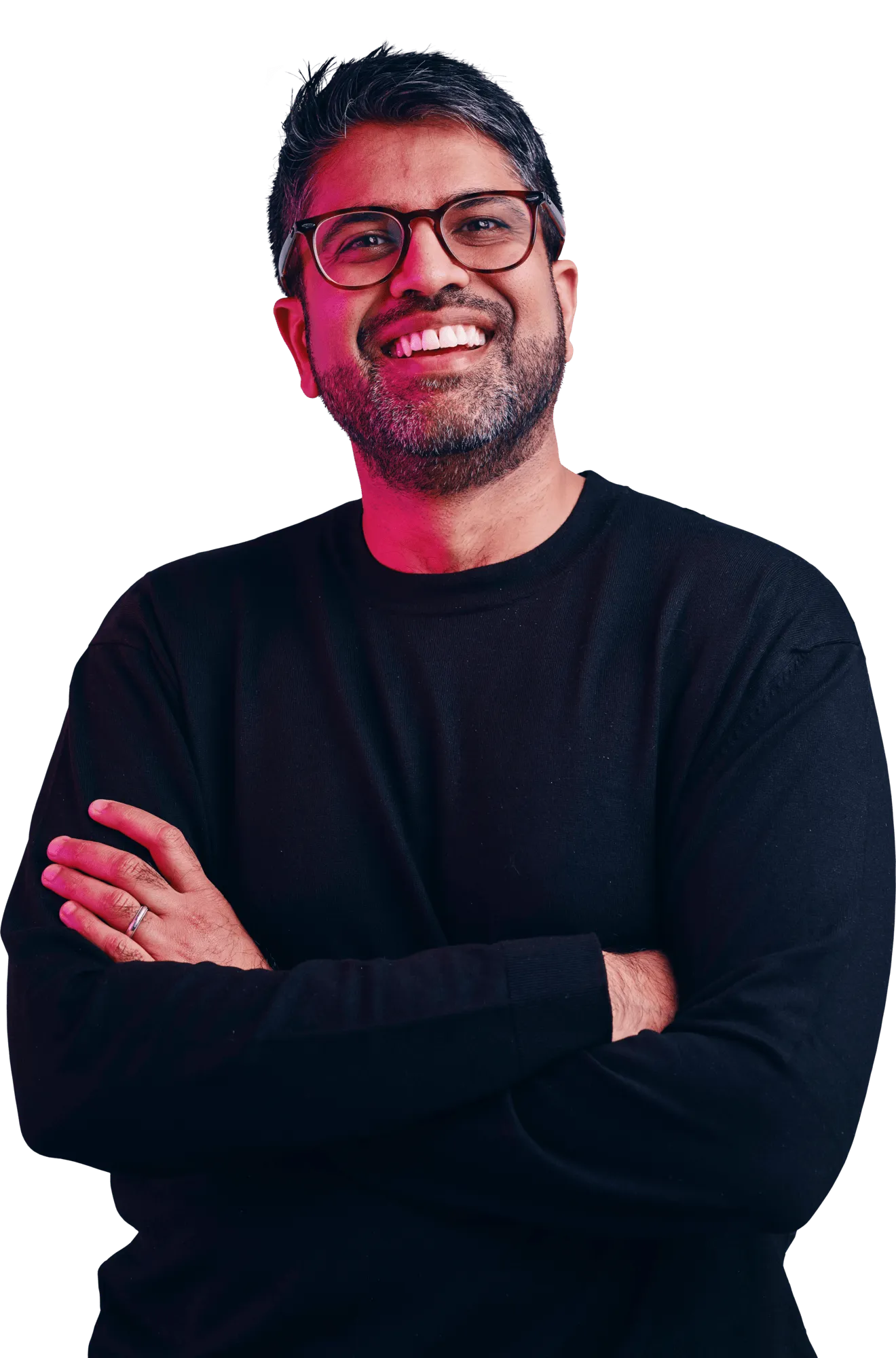 Smiling man with glasses and a beard, wearing a black long-sleeve shirt with arms crossed.