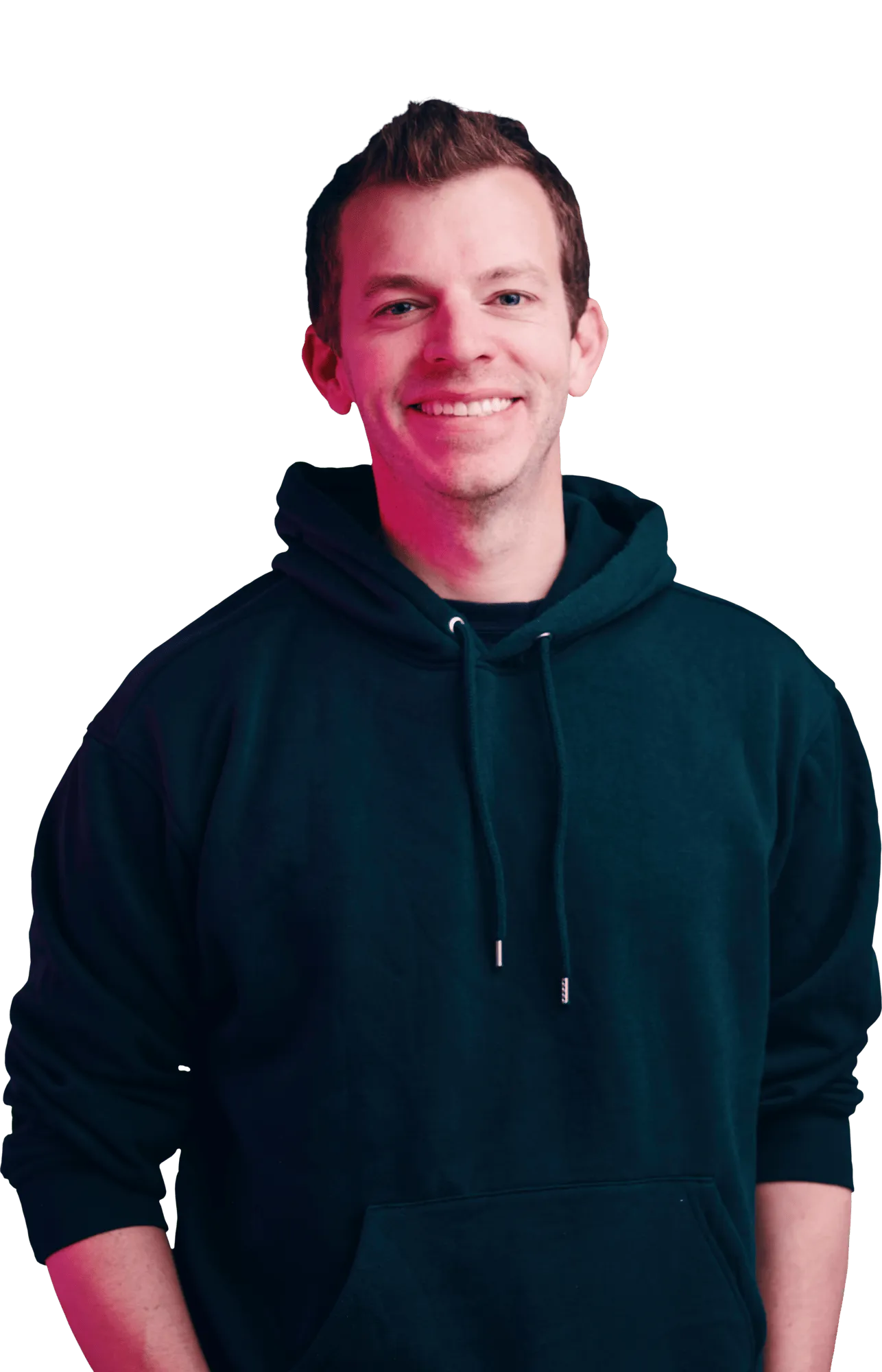 Smiling man in a dark hoodie standing against a black background.