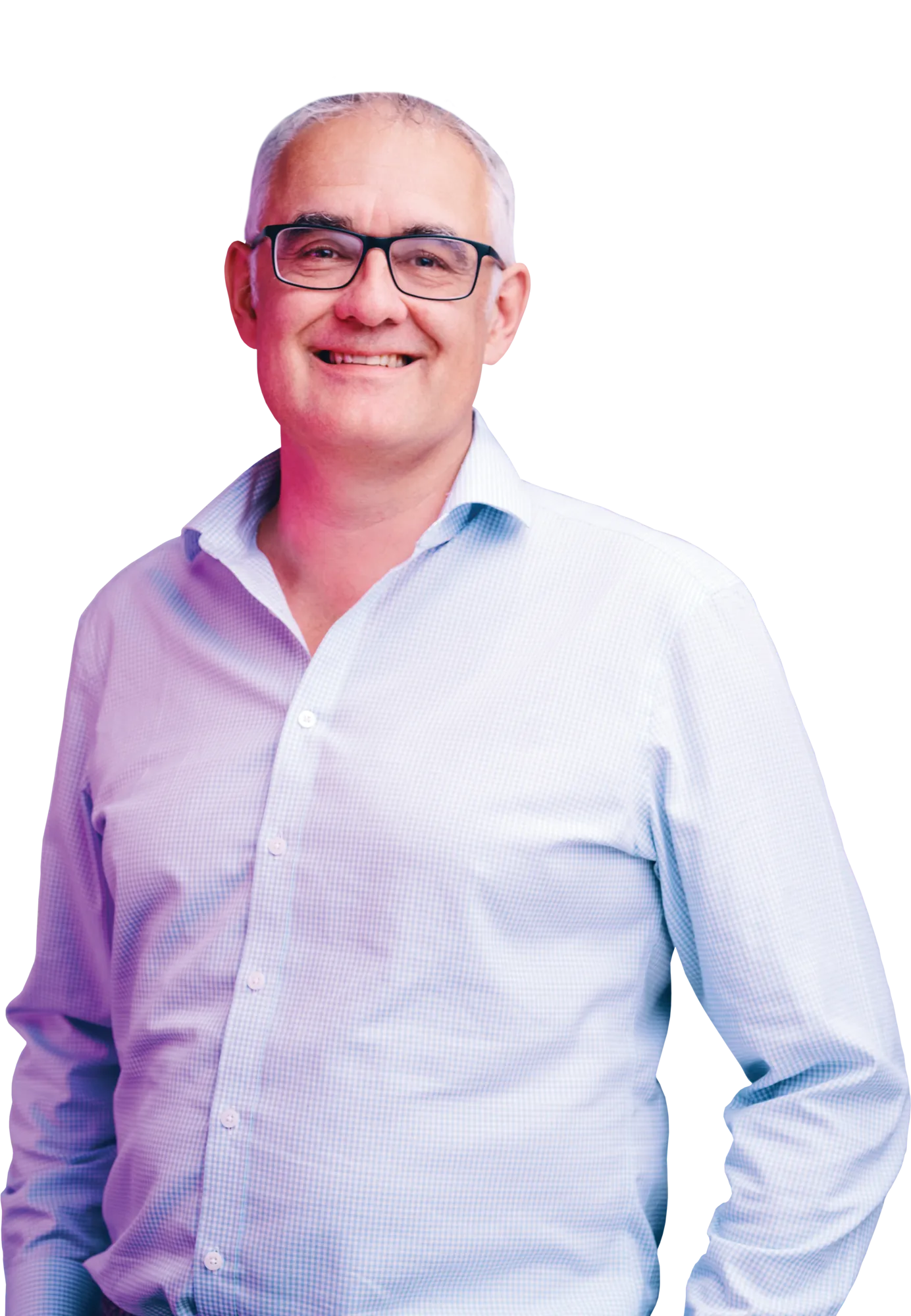 Smiling middle-aged man with gray hair and glasses wearing a light blue shirt.